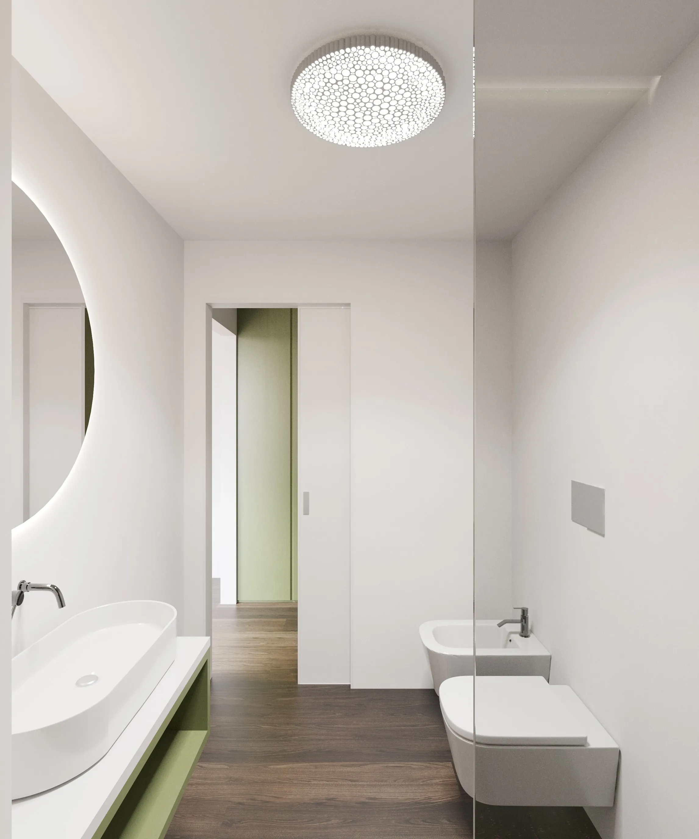 Rendering di un bagno bianco con pavimento in legno: a sinistra un lavabo ovale d’appoggio su mobile verde e un grande specchio tondo retroilluminato, in fondo una porta scorrevole aperta su un passaggio con parete verde, a destra bidet e wc sospesi oltre una parete di vetro; a soffitto una plafoniera traforata